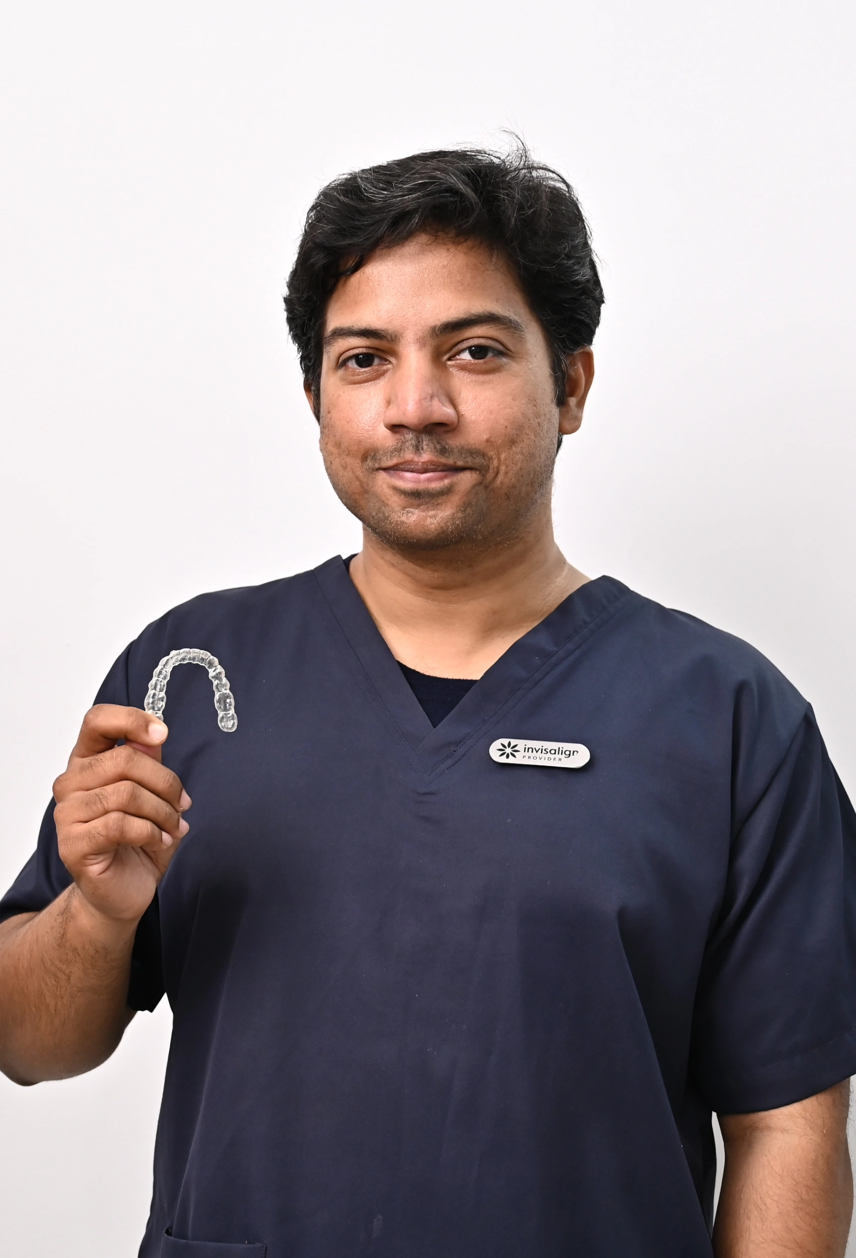 Dentist at 3D-DDS fitting a patient with clear aligners